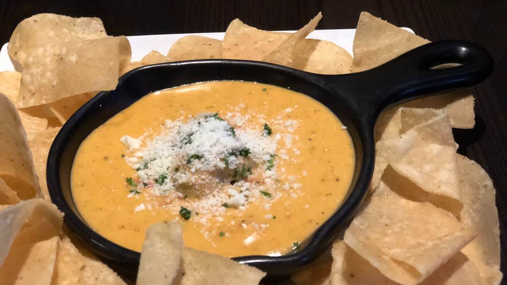 Trailrider Skillet Queso · Boar’s Head American cheese, anaheim peppers, chili's, serrano peppers, house seasoning & guacamole with house chips.