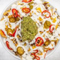 Stacked Nachos · House chips layered with queso blanco, shredded cheddar, seasoned ground beef, jalapeños, gu...