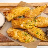 Southwest Chicken Egg Rolls · Buttermilk fried chicken tossed with buffalo sauce, celery, carrots & mixed cheeses wrapped ...