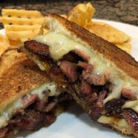 Cowboy Brisket Grilled Cheese · Smoked brisket topped with white cheddar cheese, onion-bacon jam and served between butter-g...