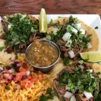 Street Tacos · Three authentic-style slow roasted & seasoned brisket tacos topped with diced white onion & ...