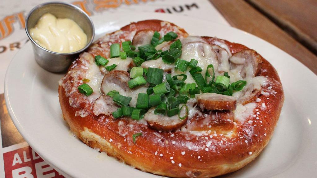 Saucer Bratzel · One pretzel topped with melted Swiss cheese, sliced bratwurst, and green onions.  Served with a side of spicy mustard.