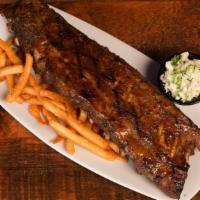 Bbq Baby Back Ribs · Dry rubbed, smoked low & slow. Memphis BBQ, crispy fries & coleslaw.