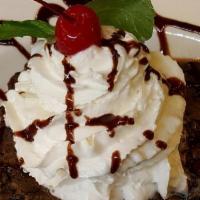 Giant Brownie Sundae · Vanilla ice cream, chocolate syrup, dusted with powdered sugar, whipped cream, & cherry.