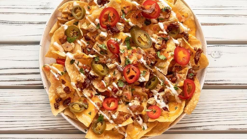 Tasty Nachos · Grilled chicken, tortilla chips, queso, pickled jalapeños, chopped bacon and pico de gallo