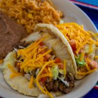 Puffy Taco Plate · Two puffy tacos filled with picadillo or shredded chicken breast, lettuce, tomato and cheese...