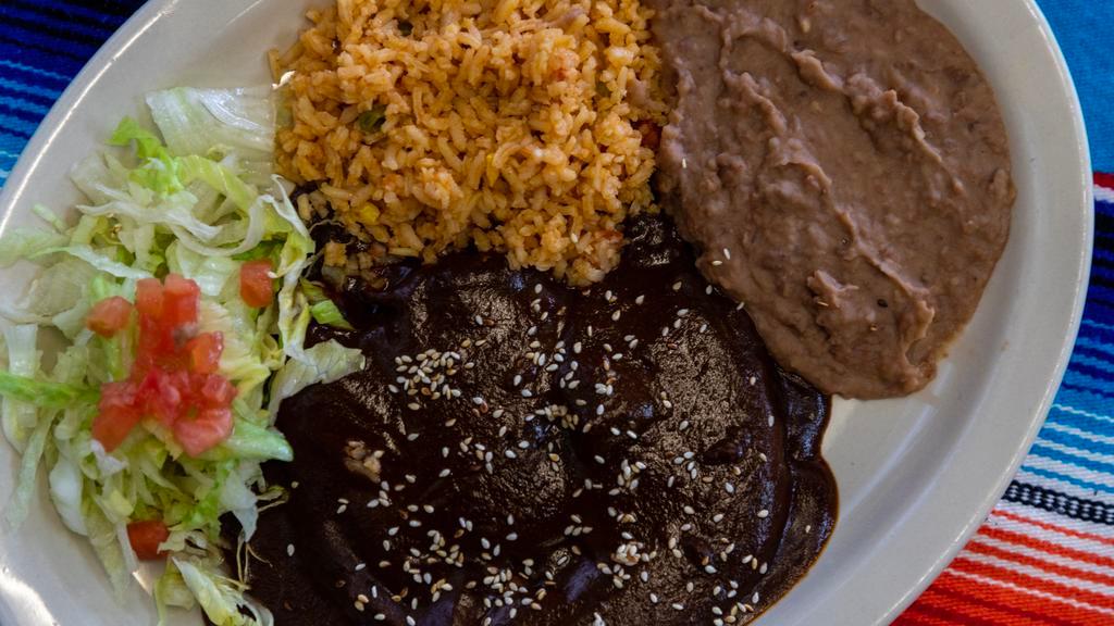 Mole Poblano Plate · Chicken leg and thigh topped with mole sauce. Served with beans, rice, salad and Two tortillas.