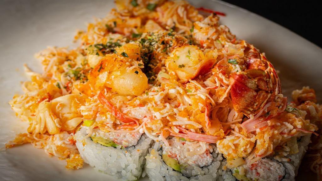 Lobster Dynamite Roll · (IN - Crabmeat, avocado) , 
(Out - Onion, crab meat, baked lobster, shrimp, and crab sticks mixed with chili oil, massago, crunch flakes and baked)