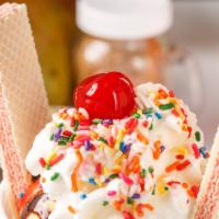Sundae · Three ice cream scoops, whip cream, wafers, sprinkles.