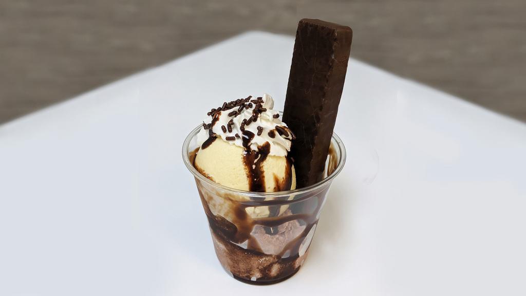 Dark Chocolate Sundae · Premium Dark chocolate wafer, Vanilla and Chocolate Ice Cream with chocolate syrup, whip cream, cherry and sprinkles.