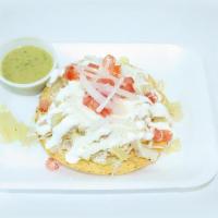 Tostada De Cueritos · Crispy corn tortilla, cabbage, cueritos (vinegar pork skins), tomato, onion, Mexican cream, ...