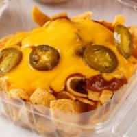 Frito Pie · Fritos, chili, nacho cheese, jalapeños. Also try with hot Cheetos or Ruffles queso.