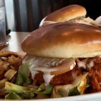 Buffalo Chicken Sandwich · Crispy fried chicken tossed in house made buffalo sauce. Served on a light toasted brioche b...