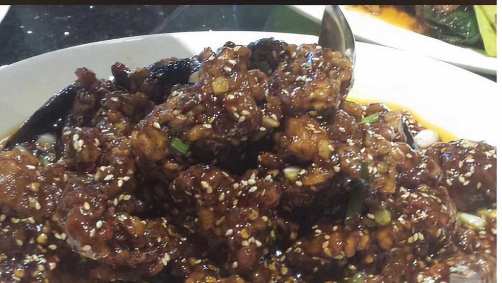 Sesame Beef · Deep fried beef sauteed in a spicy sauce and sprinkled with sesame seeds.