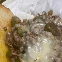Deen'S American Philly  Cheesesteaks · Thin sliced ribeye beef with American cheese, green peppers and sauteed onions.