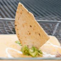Davy Dip · A delicious layering of seasoned beef, fresh guacamole, and our famous chile con queso drizz...