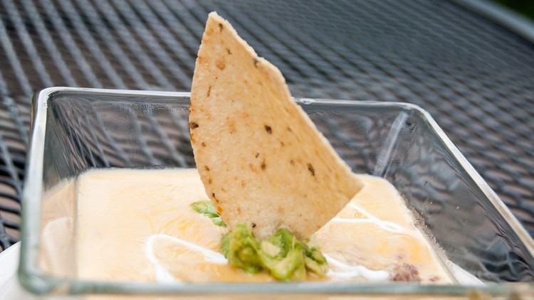 Davy Dip · A delicious layering of seasoned beef, fresh guacamole, and our famous chile con queso drizzled with sour cream.