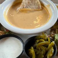 Appetizer Trio · A trio of our Fried Jalapeños (3), Beef Fajita Panchos (3), and a small Queso.  Served with ...