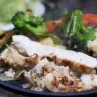 Grilled Chicken & Vegetable Fajitas · Grilled fresh vegetables and tender strips of char-broiled chicken on a bed of sautéed peppe...