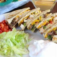 Grilled Quesadillas · Tender beef or chicken fajita meat, American, and monterey jack cheeses, and fresh pico de g...