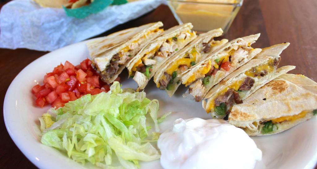 Grilled Quesadillas · Tender beef or chicken fajita meat, American, and monterey jack cheeses, and fresh pico de gallo, layered between flour tortillas.