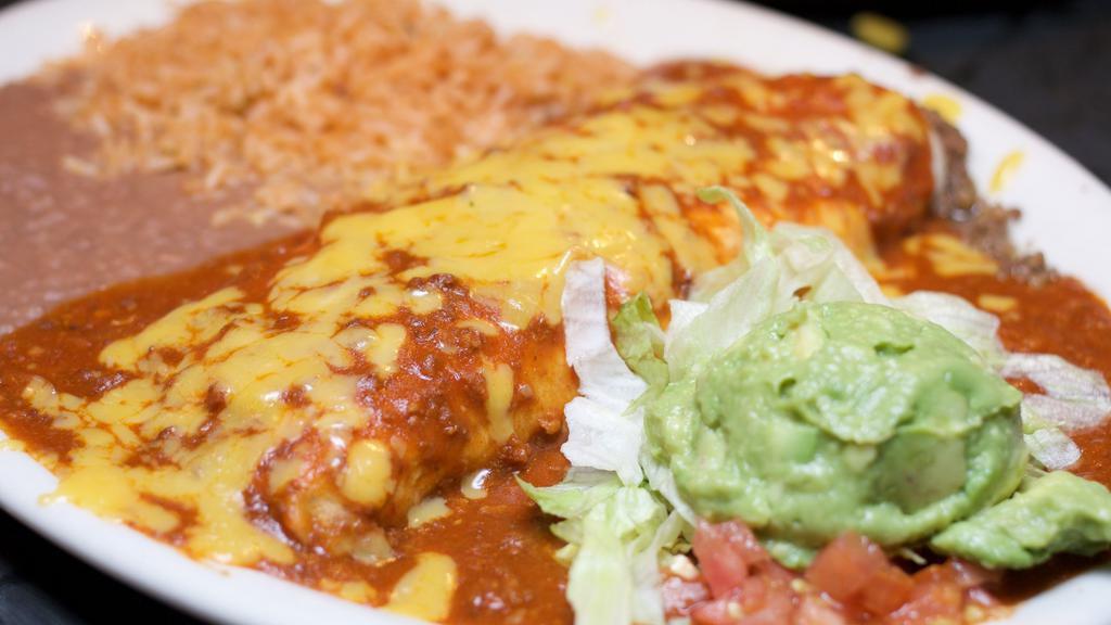 Burrito Dinner · Fresh flour (or wheat) tortilla filled with beef smothered in chile con carne or chicken smothered in ranchero sauce & rolled-to-order. Served with rice, refried beans, and guacamole.