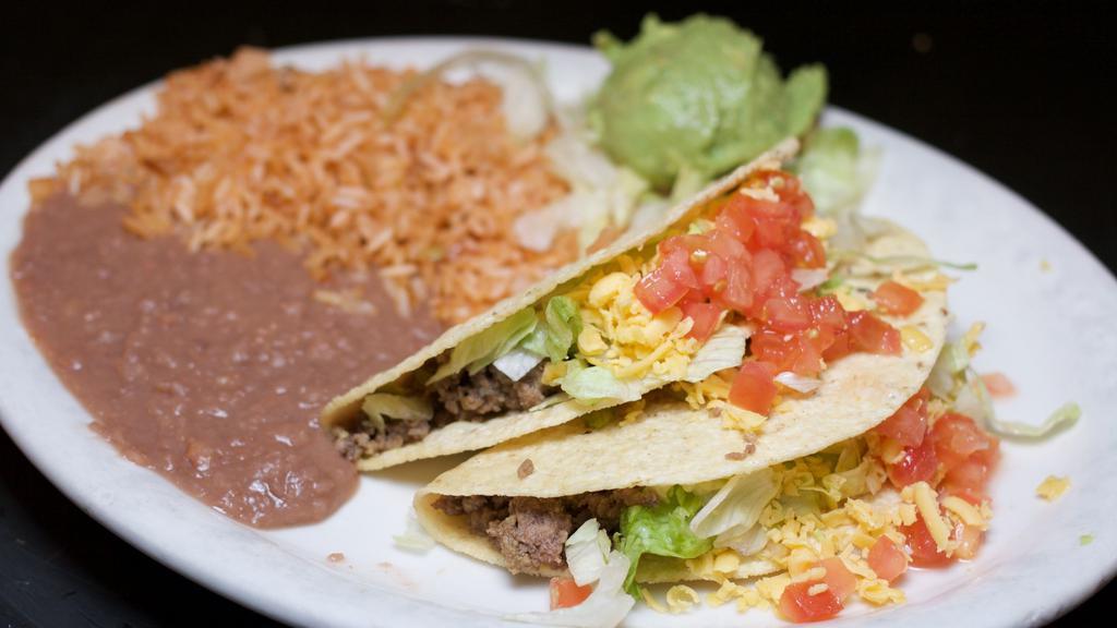 Taco Dinner · Two Soft or Crispy tacos filled with seasoned Beef or Chicken, lettuce, tomato, and shredded cheese. Served with rice, refried beans, and fresh guacamole.
