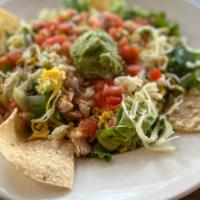 Ensalada · Crisp mixed greens topped with seasoned beef or chicken, tomatoes, American and Monterey Jac...