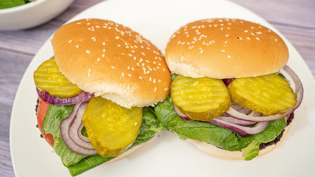 Classic Burger · Vegan. Seasoned Beyond Meat patty topped with lettuce, tomatoes, onions, and pickles between a sesame seed bun.