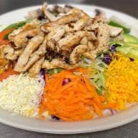 Fajita Salad · Deep-fried flour tortilla shell stuffed with lettuce and topped with a mix of sautéed onions...