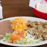 Carne Gusiada Plate · Stewed beef in brown gravy sauce. Served with salad, rice, beans and 3 tortillas.