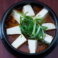 Kimchi Jjigae · Spicy Kimchi stew with firm tofu, pork, and veggies. served with rice and side dishes