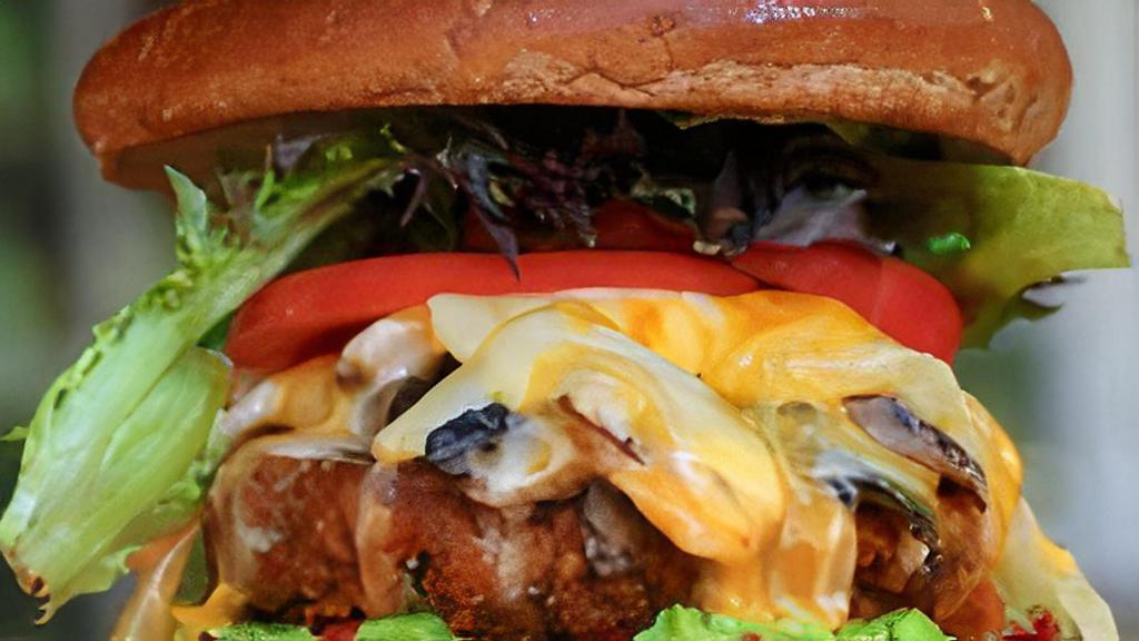 Big Nasty Burger · Our chickpea veggie patty with romaine lettuce, tomatoes, avocado, with melted cheddar, grilled onions, fakin’ bacon, grilled mushrooms and chipotle mayo.