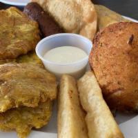 Tostones · Plantain banana cut into disks, lightly fried, and served with mojo.
