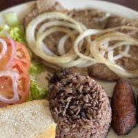 Bistec De Palomilla · Signature Cuban steak seasoned with garlic and mojo then seared '''a la plancha''' and toppe...
