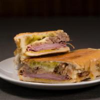 Cubano · Roasted pulled pork, ham, Swiss cheese, pickles, mayo, and mustard. Sandwiches are served wi...