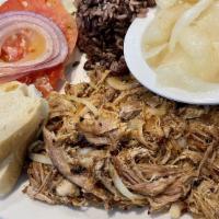 Pan Con Lechon · Slow roasted pulled pork with onions and mayonnaise. Sandwiches are served with lays chips a...