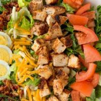 Chicken Cobb Salad · Chicken breast, bacon, chopped eggs, cheese, tomatoes on a bed of lettuce served with your c...