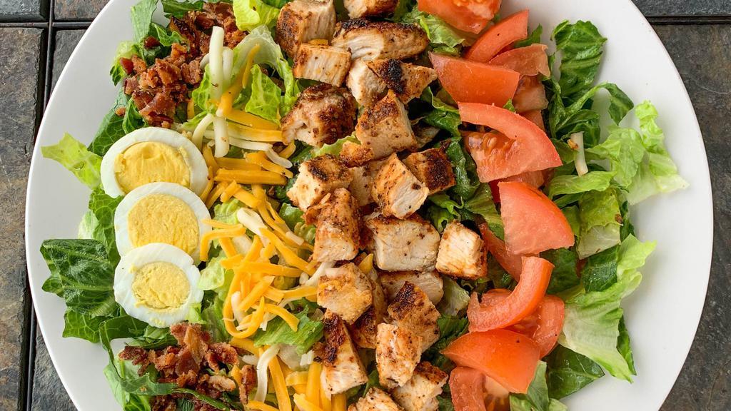 Chicken Cobb Salad · Chicken breast, bacon, chopped eggs, cheese, tomatoes on a bed of lettuce served with your choice of dressing.