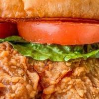 Chicken Breast Sandwich · Chicken breast with lettuce and tomato on a toasted bun served with two sides.