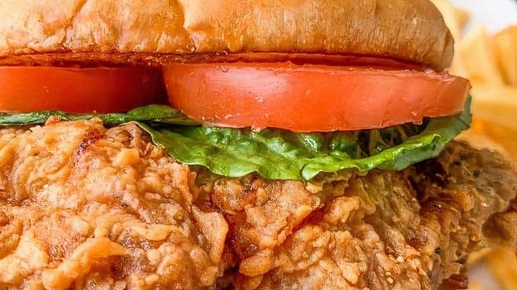 Chicken Breast Sandwich · Chicken breast with lettuce and tomato on a toasted bun served with two sides.
