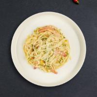 Shrimp Scampi · Sauteed shrimp with garlic and herbs in a white wine lemon butter sauce over linguine