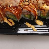 Yammy Yammy Roll · Imitation crab, avocado, cucumber, wrapped with salmon on top, drizzled with eel sauce, spic...