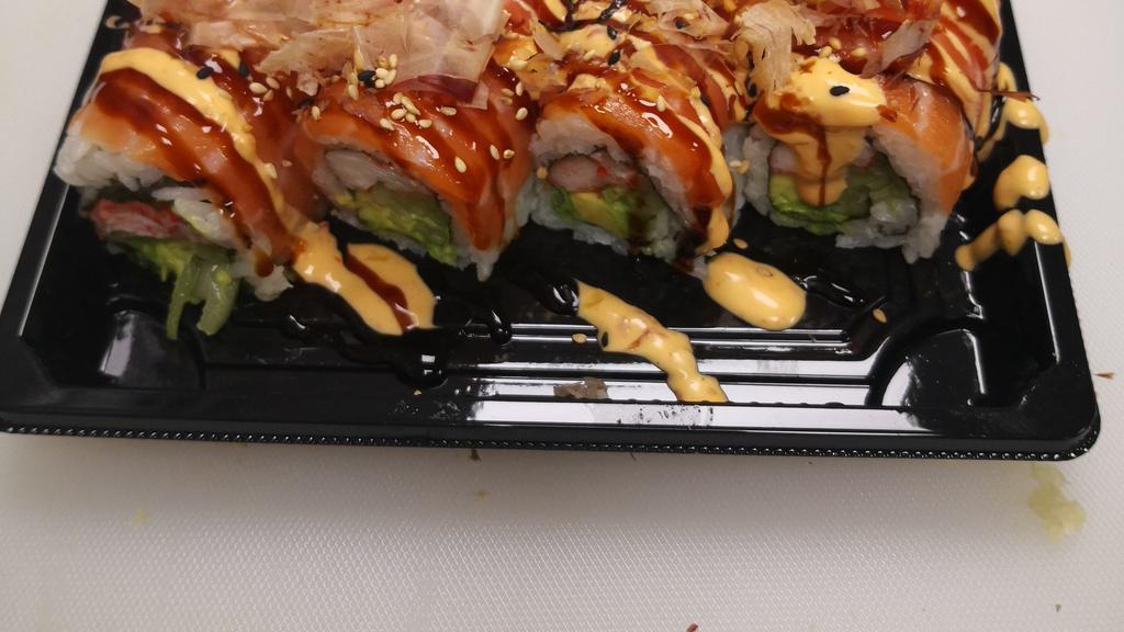 Yammy Yammy Roll · Imitation crab, avocado, cucumber, wrapped with salmon on top, drizzled with eel sauce, spicy mayo, and bonito flakes.