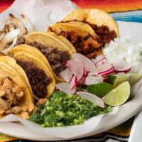 Tacos (Flour) · Choice of meat on flour tortillas served with cilantro, onion, and limes