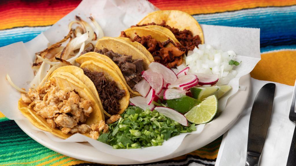 Tacos (Flour) · Choice of meat on flour tortillas served with cilantro, onion, and limes
