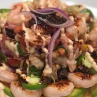 Tostada Mazatlan · Delicious FISH CEVICHE over a bed of Shrimp and Avocado, with our special Chipotle Cream and...