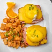 Classic Eggs Benedict · *Two poached eggs, choice of bacon, sausage, or ham on a toasted English muffin, topped with...