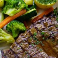 Grilled Ribeye · Served with vegetables.
