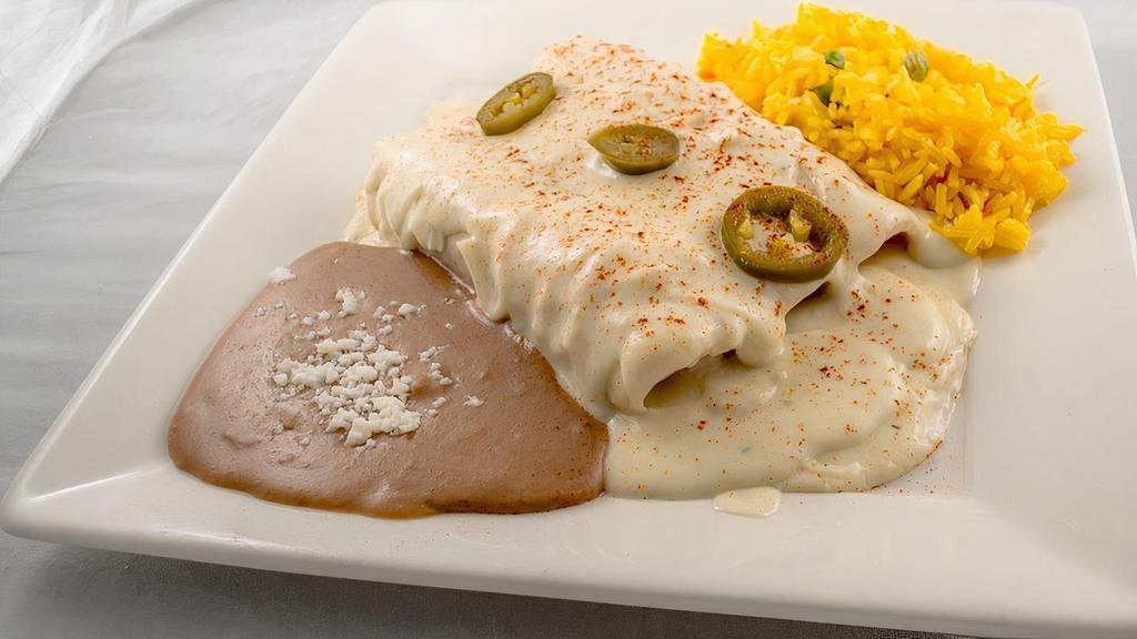 Enchiladas · Two enchiladas with meat and sauce. Served with refried beans and rice.